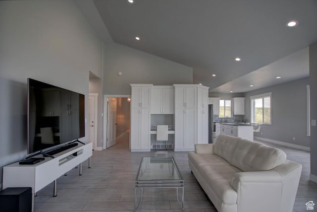 728 Loveland Ln, Fish Haven, ID 83287 - living area featuring light wood-type flooring, recessed lighting, high vaulted ceiling, and baseboards
