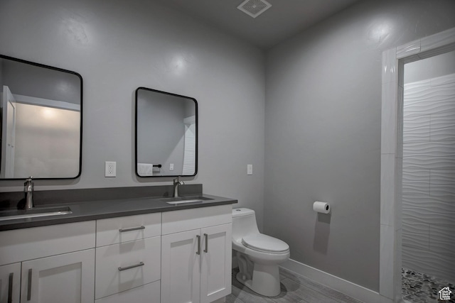 728 Loveland Ln, Fish Haven, ID 83287 - bathroom with double vanity, visible vents, toilet, and a sink