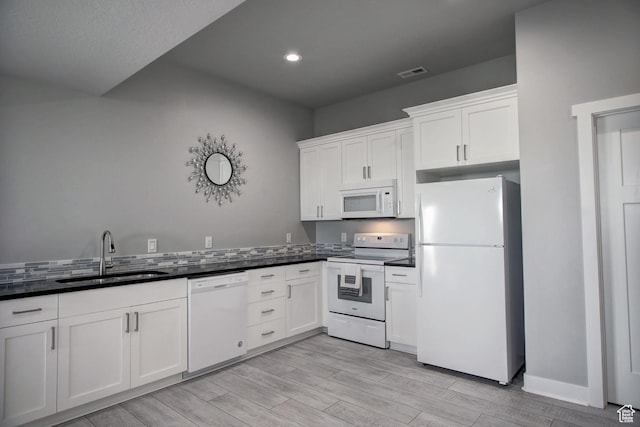 728 Loveland Ln, Fish Haven, ID 83287 - kitchen with visible vents, white appliances, dark countertops, and a sink