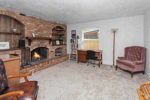 carpeted living room featuring a fireplace, a textured ceiling, and baseboards