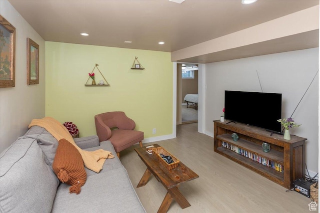 living area with baseboards, recessed lighting, and wood finished floors