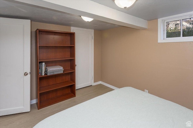 bedroom featuring baseboards and light wood-style floors