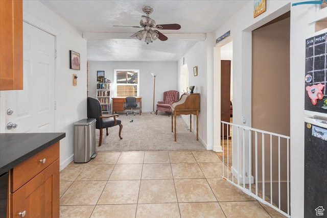 interior space featuring light tile patterned floors, light colored carpet, and baseboards