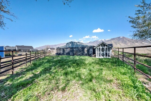 302 Old Farm Rd, Erda, UT 84074 - view of yard featuring fence, an outdoor structure, and a mountain view