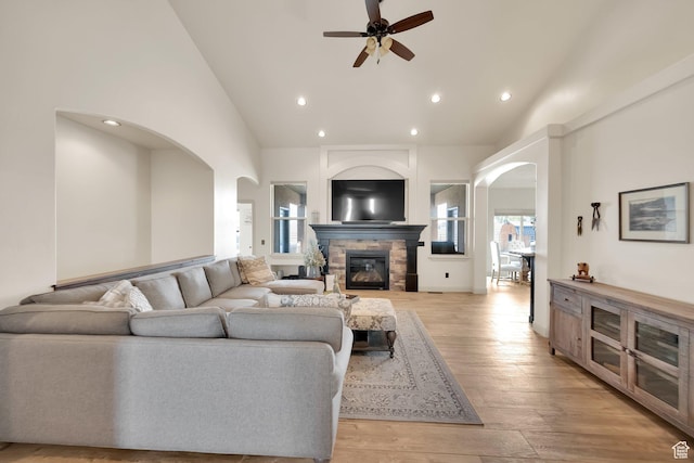 302 Old Farm Rd, Erda, UT 84074 - living room featuring ceiling fan, recessed lighting, a stone fireplace, and arched walkways