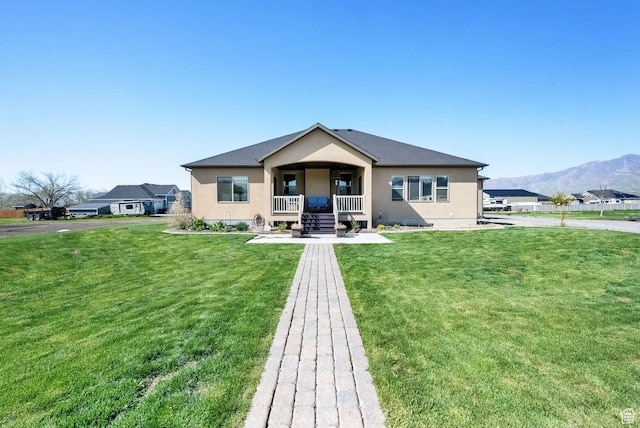 302 Old Farm Rd, Erda, UT 84074 - back of house featuring covered porch, a mountain view, stucco siding, and a yard