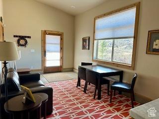 620 W Cisco Run Run, Garden City, UT 84028 - dining room featuring baseboards, light carpet, and vaulted ceiling