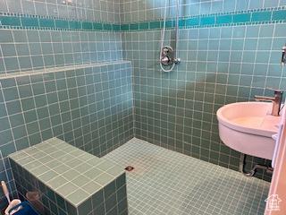 620 W Cisco Run Run, Garden City, UT 84028 - bathroom featuring tile walls, a tile shower, and a sink