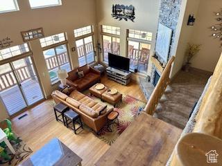 620 W Cisco Run Run, Garden City, UT 84028 - living area with wood finished floors, a stone fireplace, and a towering ceiling
