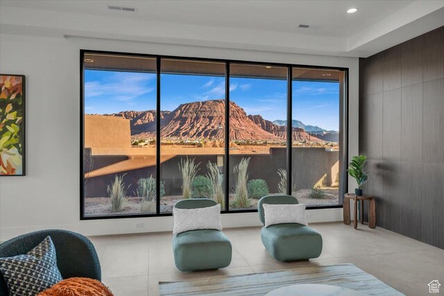 533 S Kwavasa Dr, Ivins, UT 84738 - living area with tile patterned floors, a mountain view, visible vents, and a healthy amount of sunlight