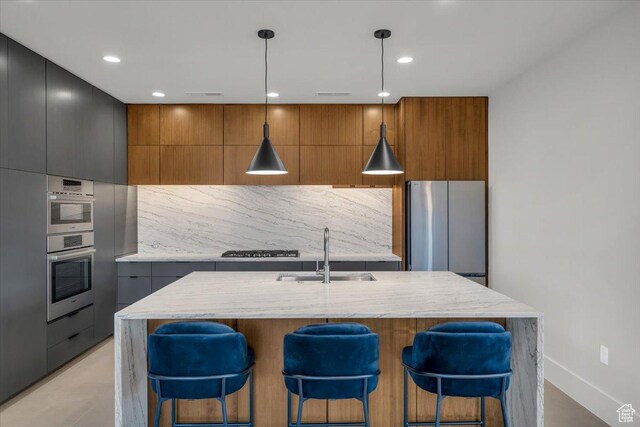 533 S Kwavasa Dr, Ivins, UT 84738 - kitchen featuring modern cabinets, a sink, gas stovetop, decorative backsplash, and freestanding refrigerator