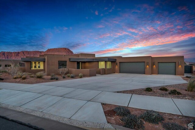 533 S Kwavasa Dr, Ivins, UT 84738 - pueblo-style house featuring stucco siding, driveway, and an attached garage