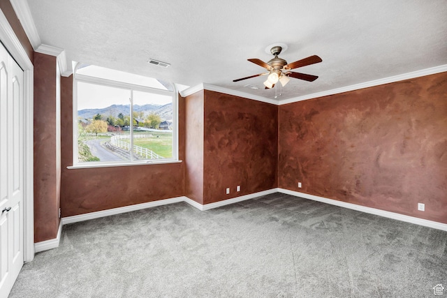 1910 E Canyon Ridge Dr, North Logan, UT 84341 - spare room featuring a mountain view, a ceiling fan, visible vents, carpet, and baseboards