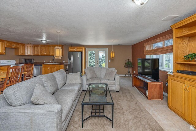 1910 E Canyon Ridge Dr, North Logan, UT 84341 - living area with light tile patterned floors, a textured ceiling, and french doors