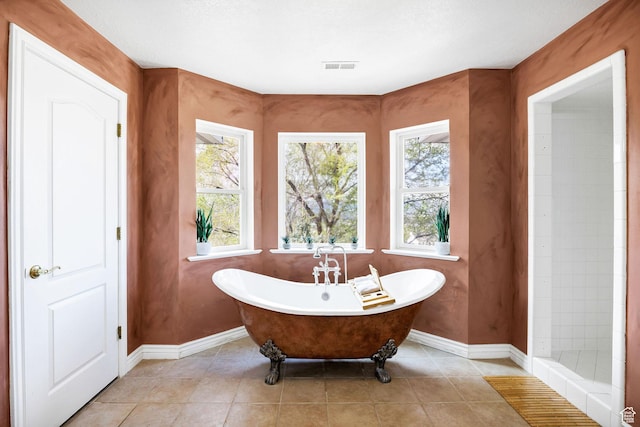 1910 E Canyon Ridge Dr, North Logan, UT 84341 - bathroom featuring baseboards, visible vents, a freestanding tub, and tile patterned floors