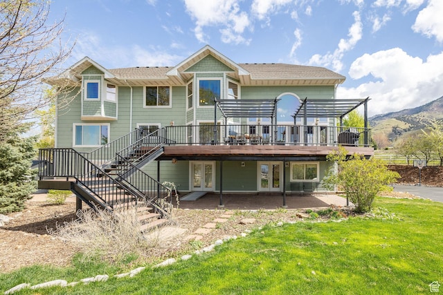 1910 E Canyon Ridge Dr, North Logan, UT 84341 - rear view of property featuring stairs, a patio, a deck with mountain view, a lawn, and french doors