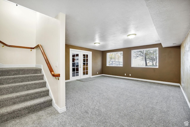 1910 E Canyon Ridge Dr, North Logan, UT 84341 - unfurnished living room with a textured ceiling, carpet flooring, french doors, and baseboards