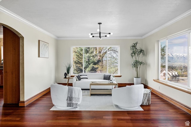 1910 E Canyon Ridge Dr, North Logan, UT 84341 - living area with a chandelier, baseboards, ornamental molding, arched walkways, and wood finished floors