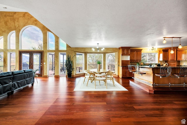 1910 E Canyon Ridge Dr, North Logan, UT 84341 - dining area with an inviting chandelier, a textured ceiling, and dark wood-type flooring