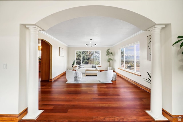 1910 E Canyon Ridge Dr, North Logan, UT 84341 - living room with decorative columns, arched walkways, wood finished floors, and ornamental molding