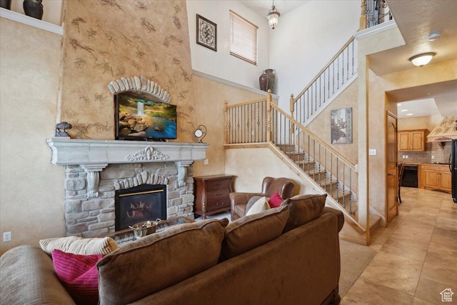 3634 N Huntsman Path Unit C201, Eden, UT 84310 - living room featuring stairway, a high ceiling, light tile patterned flooring, and a fireplace