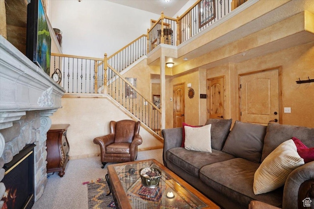 3634 N Huntsman Path Unit C201, Eden, UT 84310 - living area featuring carpet, stairway, a stone fireplace, and a high ceiling