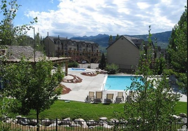 3634 N Huntsman Path Unit C201, Eden, UT 84310 - pool with a mountain view, fence, a patio area, and a lawn