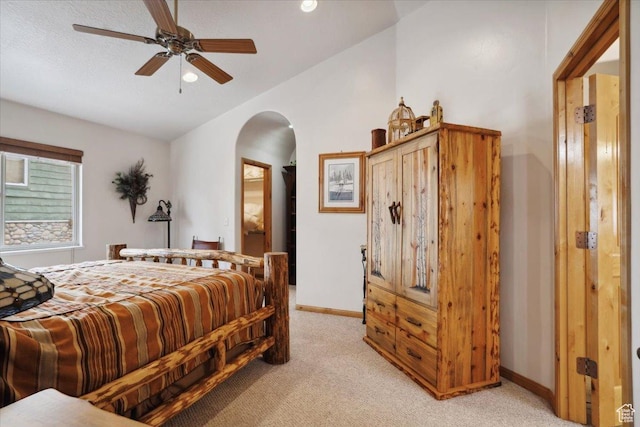 3634 N Huntsman Path Unit C201, Eden, UT 84310 - bedroom featuring arched walkways, ceiling fan, light carpet, baseboards, and lofted ceiling