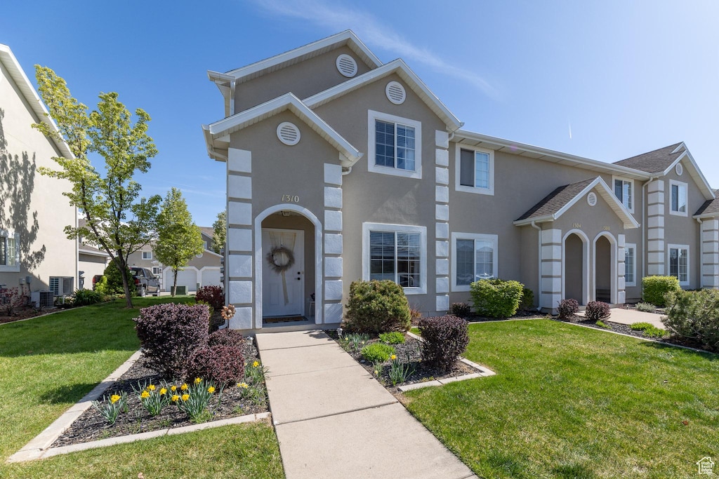 1310 E 6125 S, South Ogden, UT 84405 - view of front facade featuring a front yard, central air condition unit, and stucco siding