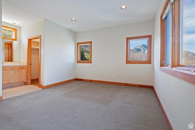 152 N Silver Oak Rd, Salt Lake City, UT 84108 - unfurnished bedroom with baseboards, multiple windows, and light colored carpet