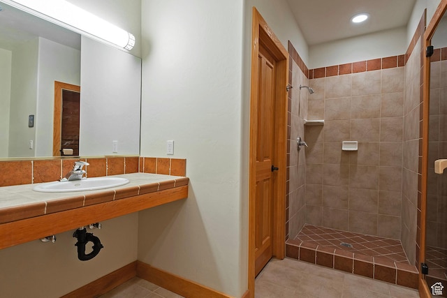 152 N Silver Oak Rd, Salt Lake City, UT 84108 - bathroom featuring recessed lighting, tiled shower, tile patterned flooring, and a sink