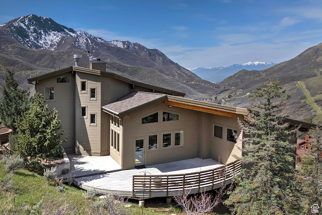 152 N Silver Oak Rd, Salt Lake City, UT 84108 - rear view of property featuring a deck with mountain view and a chimney