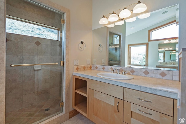 152 N Silver Oak Rd, Salt Lake City, UT 84108 - bathroom with vaulted ceiling, a shower stall, vanity, and plenty of natural light