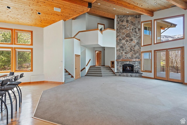 152 N Silver Oak Rd, Salt Lake City, UT 84108 - unfurnished living room with wood ceiling, a stone fireplace, baseboards, stairway, and a high ceiling