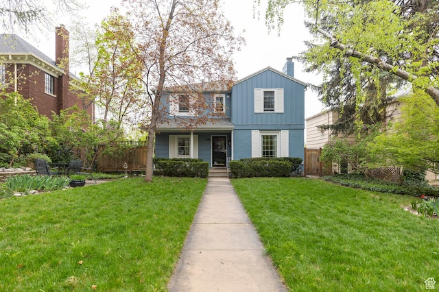 1280 E 3rd Ave N, Salt Lake City, UT 84103 - traditional-style house with a chimney, fence, and a front yard