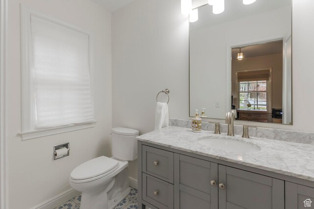 1280 E 3rd Ave N, Salt Lake City, UT 84103 - bathroom with baseboards, toilet, tile patterned flooring, and vanity