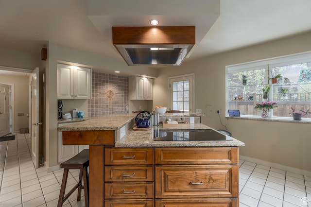 1280 E 3rd Ave N, Salt Lake City, UT 84103 - kitchen with light tile patterned floors, white cabinetry, a center island, ventilation hood, and black electric cooktop
