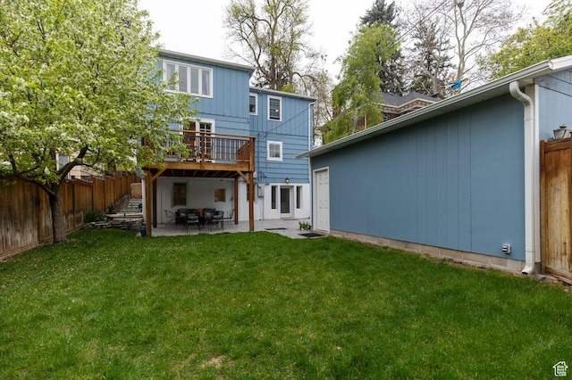 1280 E 3rd Ave N, Salt Lake City, UT 84103 - back of house featuring a patio, a fenced backyard, a wooden deck, and a lawn