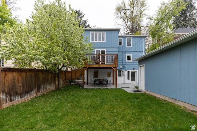 1280 E 3rd Ave N, Salt Lake City, UT 84103 - back of property featuring a patio, a deck, a lawn, and a fenced backyard