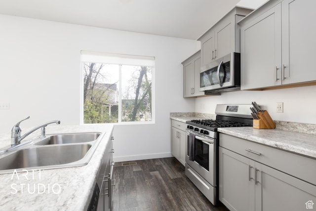 661 W 1820 S, Provo, UT 84601 - kitchen featuring dark wood-style floors, a sink, gray cabinets, baseboards, and appliances with stainless steel finishes