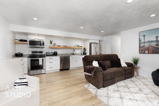 661 W 1820 S, Provo, UT 84601 - living area with a textured ceiling, light wood-style floors, recessed lighting, and indoor wet bar