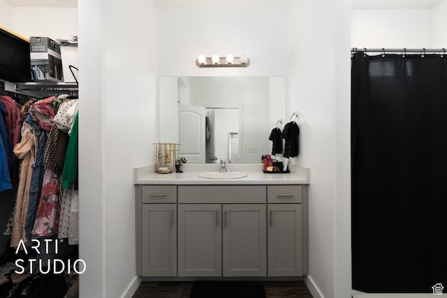 661 W 1820 S, Provo, UT 84601 - full bathroom with wood finished floors, a spacious closet, vanity, and baseboards