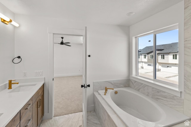 bathroom featuring marble finish floor, a ceiling fan, a bath, and vanity