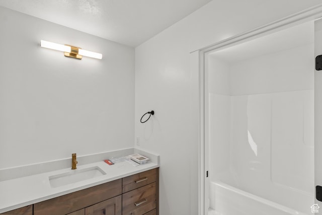 bathroom featuring shower / bathtub combination and vanity