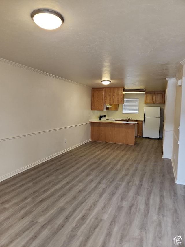 1514 S 200 E, Orem, UT 84058 - kitchen with freestanding refrigerator, brown cabinets, ornamental molding, a peninsula, and open floor plan