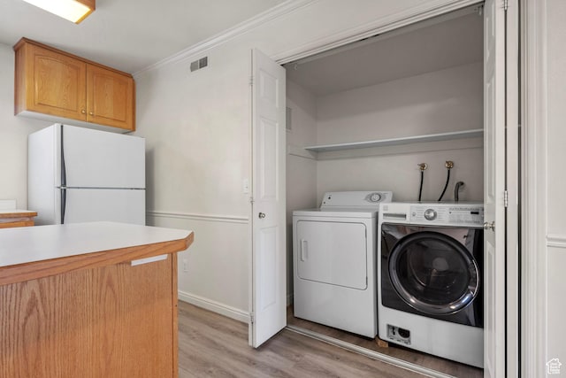 1514 S 200 E, Orem, UT 84058 - laundry room featuring light wood-type flooring, washer and clothes dryer, and crown molding