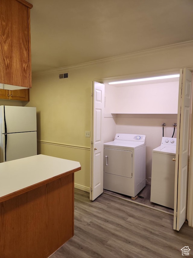 1514 S 200 E, Orem, UT 84058 - laundry area with washer and clothes dryer, laundry area, visible vents, ornamental molding, and wood finished floors