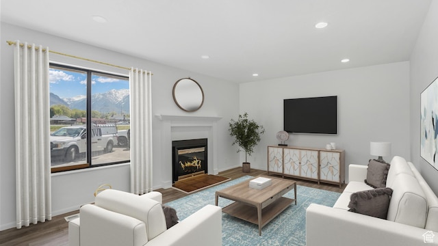 687 E 8800 S, Sandy, UT 84070 - living room with wood finished floors, a mountain view, recessed lighting, a fireplace with flush hearth, and baseboards