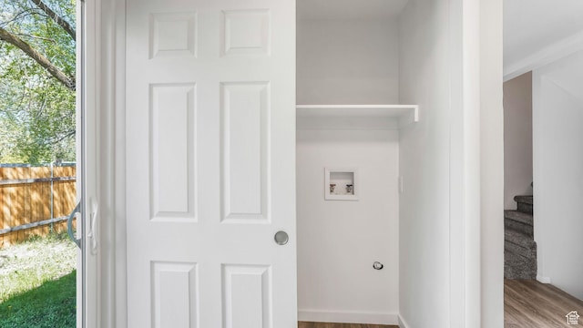 laundry area with hookup for a washing machine, wood finished floors, and laundry area