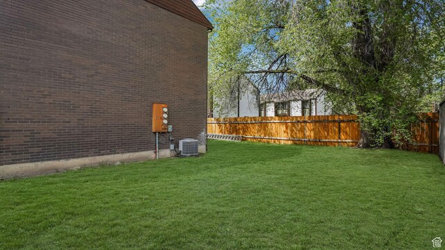 view of yard featuring central AC and a fenced backyard